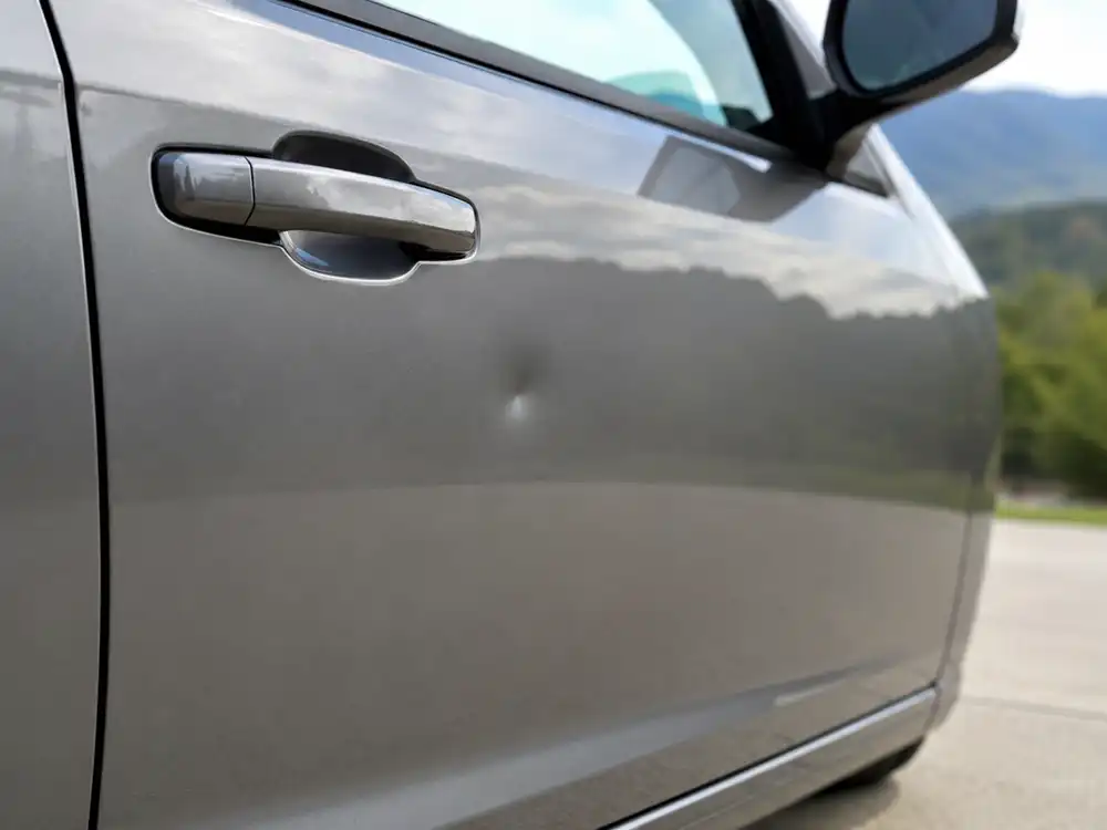 Small car dent on vehicle door needing paintless dent repair in Western NC